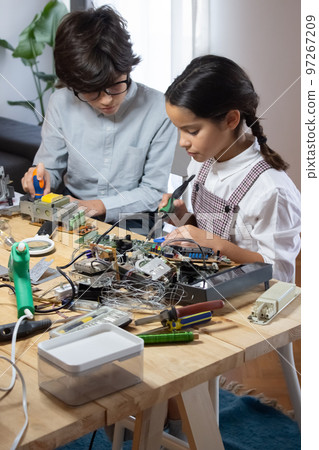 Concentrated children having popular robotics class 97267209