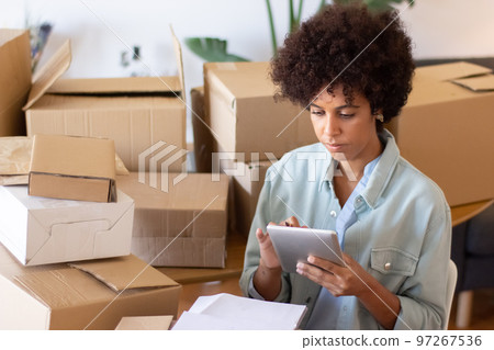 Busy African American woman using tablet 97267536