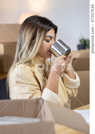 Young office employee drinking from mug 97267636