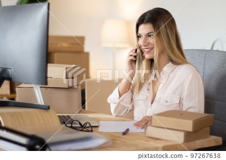 Young online shop assistant consulting client on phone 97267638