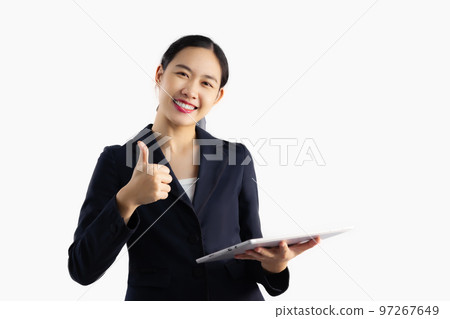 Asian businesswoman in black jacket holding tablet computer posing smiling and thump up on white background.. 97267649