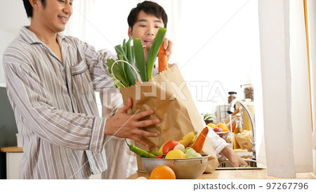 Asian people happy time smile, laugh in kitchen. Best friend LGBTQ lifestyle. Happy Asian gay couple homosexual cooking together in kitchen prepare fresh vegetable make organic salad healthy food. Asian people happy time smile, laugh in kitchen. Best friend LGBTQ lifestyle. Happy Asian gay couple homosexual cooking together in kitchen prepare fresh vegetable make organic salad healthy food. 97267796