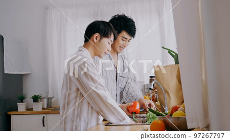 Happy Asian gay couple homosexual cooking together in kitchen prepare fresh vegetable make organic salad healthy food. Asian people happy time smile, laugh in kitchen. Best friend LGBTQ lifestyle Happy Asian gay couple homosexual cooking together in kitchen prepare fresh vegetable make organic salad healthy food. Asian people happy time smile, laugh in kitchen. Best friend LGBTQ lifestyle 97267797