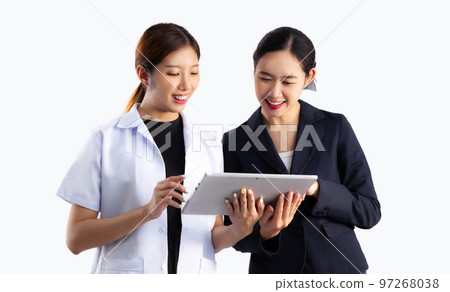 Asian doctor and businesswomen looking lablet discussing on white background.. 97268038