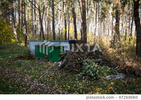 Green metal containers for collecting garbage in the forest. Green metal containers for collecting garbage in the forest. 97268060