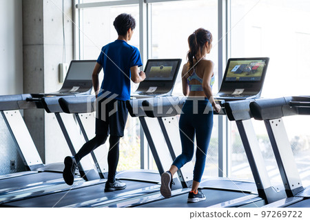 Young men and women training in the gym Young men and women training in the gym 97269722