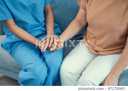 A contented senior woman visited by her personal caregiver. 97270065