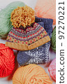 Knitting. Knitting warm clothes on your own. Tangles of wool and knitted things 97270221