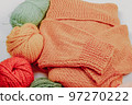 Knitting. Knitting warm clothes on your own. Tangles of wool and knitted things 97270222