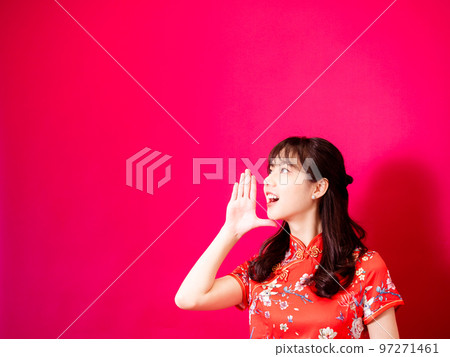 Cute asian girl wearing red chinese traditional cheongsam shouting for chinese new year celebration 97271461