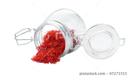 Dried saffron spices spill out of a glass storage jar isolated on white background. Dried saffron spices spill out of a glass storage jar isolated on white background. 97271553