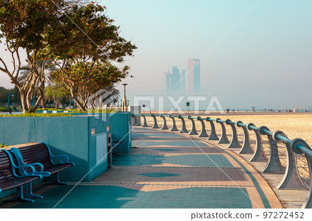 Abu Dhabi Skyline from Corniche. Abu Dhabi, Modern Skyscrapers and Landmark. Promenade in Abu Dhabi. United Arab Emirates, Middle East. Abu Dhabi Skyline from Corniche. Abu Dhabi, Modern Skyscrapers and Landmark. Promenade in Abu Dhabi. United Arab Emirates, Middle East. 97272452