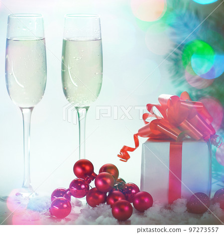 two glasses with champagne, and boxes with gifts on Christmas b 97273557
