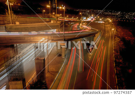 Light trails of passing cars Light trails of passing cars 97274387