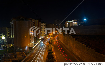 Light trails of passing cars Light trails of passing cars 97274388