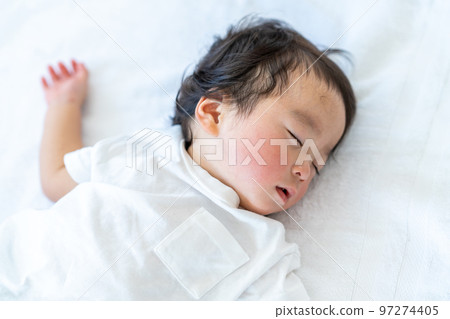 A baby taking a nap. 97274405