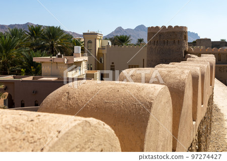 Nizwa city walls. Traditional medieval architecture in Nizwa, Oman. Nizwa city walls. Traditional medieval architecture in Nizwa, Oman. 97274427
