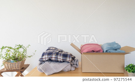 Clothes in cardboard | Changing, discarding, and recycling image 97275544