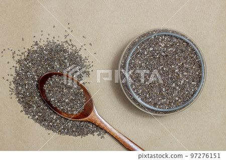 Healthy food, Chia seeds or superfood in glass jar and wooden spoon on cardboard texture background Healthy food, Chia seeds or superfood in glass jar and wooden spoon on cardboard texture background 97276151