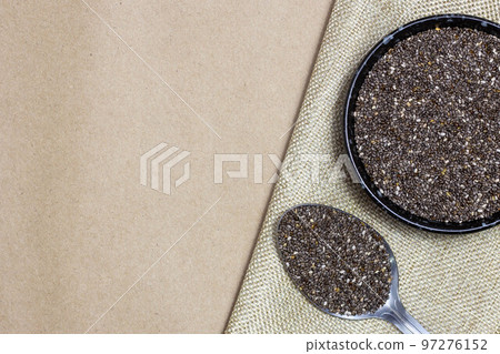 Healthy and diet food, Chia seeds or superfood in black bowl with spoon on linen cloth Healthy and diet food, Chia seeds or superfood in black bowl with spoon on linen cloth 97276152