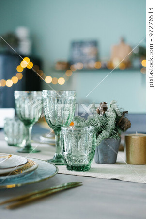 Green glass glasses for a festive Christmas dinner Green glass glasses for a festive Christmas dinner 97276513