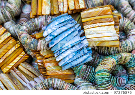 Colorful bracelet with decorative stones and shells. Souvenirs exhibited in market shops of the old town Nizwa. Oman. Arabian Peninsula.  97276876