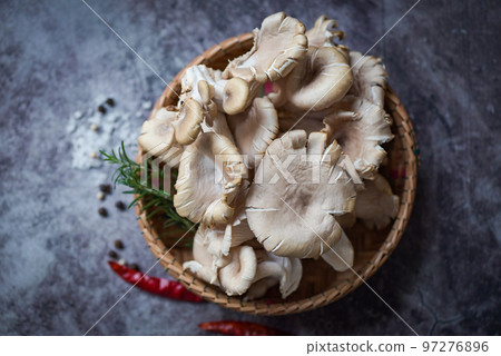 Grey oyster mushroom on basket , fresh raw oyster mushroom with herbs and spices for cooking food Grey oyster mushroom on basket , fresh raw oyster mushroom with herbs and spices for cooking food 97276896