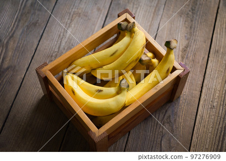 bunch of bananas - banana on wooden box background, ripe banana fruit on floor bunch of bananas - banana on wooden box background, ripe banana fruit on floor 97276909