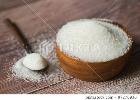 Sugar on spoon and wooden bowl, white sugar for food and sweets dessert candy heap of sweet sugar crystalline granulated Sugar on spoon and wooden bowl, white sugar for food and sweets dessert candy heap of sweet sugar crystalline granulated 97276930