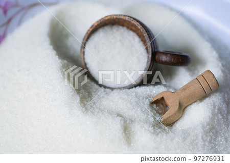 Sugar with cup and wooden scoop, white sugar for food and sweets dessert candy heap of sweet sugar crystalline granulated Sugar with cup and wooden scoop, white sugar for food and sweets dessert candy heap of sweet sugar crystalline granulated 97276931