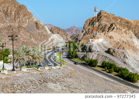 Road with palm trees. Traditional Omani architecture. Old Town of Muscat, Oman. Arabian Peninsula.  97277345