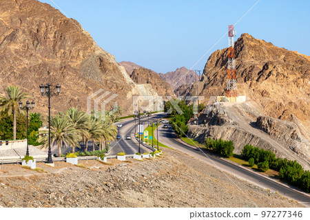 Road with palm trees. Traditional Omani architecture. Old Town of Muscat, Oman. Arabian Peninsula.  97277346