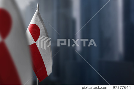 Small flags of Greenland on a blurry background of the city Small flags of Greenland on a blurry background of the city 97277644