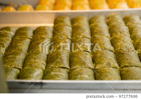 Various types or many colorful assortment of Turkish sweets for sale in street shop food festival. Baklava and pastries are sold on trays on the counter. Travel  97277686
