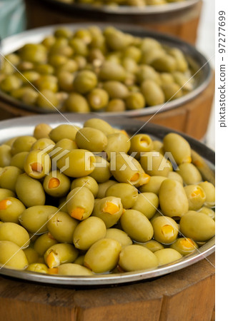 Different marinated olives and local food on street market in Gdansk, Poland. Selling and buying street food. Assortment of Appetizing olives on market 97277699
