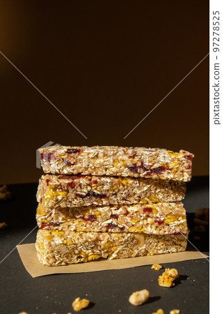 Homemade Granola energy bar. Variety of homemade protein granola breakfast bars with nuts, raisins dried cherries and chocolate. Healthy nutrition eating Gluten free cereal dieting snack super food 97278525