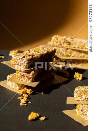 Homemade Granola energy bar. Variety of homemade protein granola breakfast bars, with nuts, raisins dried cherries and chocolate. Healthy nutrition eating Gluten free cereal dieting snack super food Homemade Granola energy bar. Variety of homemade protein granola breakfast bars, with nuts, raisins dried cherries and chocolate. Healthy nutrition eating Gluten free cereal dieting snack super food 97278528