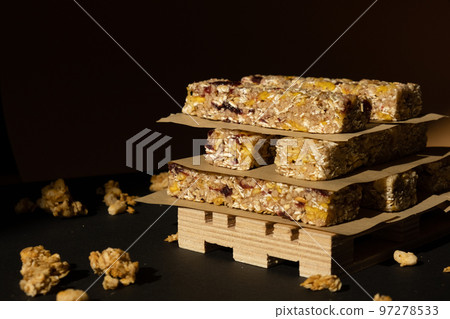 Homemade Granola energy bar. Variety of homemade protein granola breakfast bars with nuts, raisins dried cherries and chocolate. Healthy nutrition eating Gluten free cereal dieting snack super food Homemade Granola energy bar. Variety of homemade protein granola breakfast bars with nuts, raisins dried cherries and chocolate. Healthy nutrition eating Gluten free cereal dieting snack super food 97278533