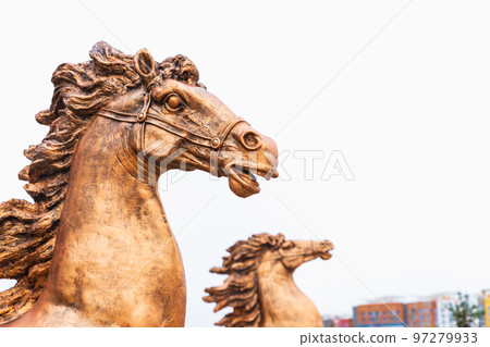 Bronze horse muzzle sculpture with flying mane on city street, close-up Bronze horse muzzle sculpture with flying mane on city street, close-up 97279933
