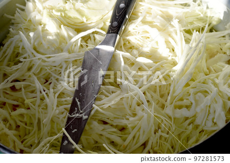 Shredded cabbage and a wide knife. 97281573