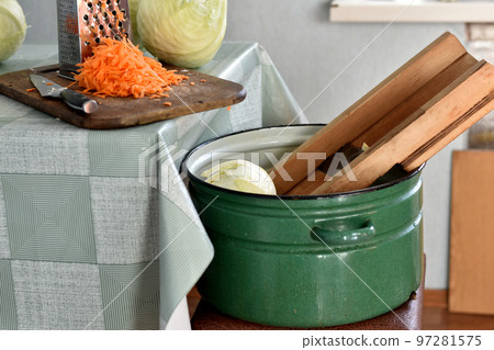 A saucepan, a shredder and a cabbage fork lies on the tool. A saucepan, a shredder and a cabbage fork lies on the tool. 97281575