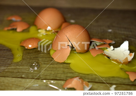 Broken egg shells, yolk and white. 97281786