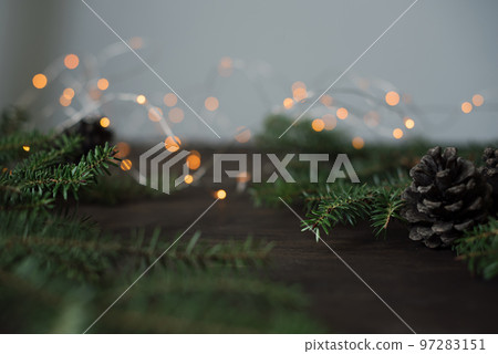 Minimalistic winter christmas background. Fir branches and cones on a wooden table. 97283151