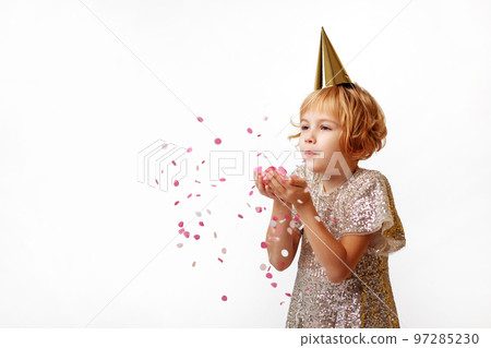Happy child girl blowing confetti Happy child girl blowing confetti 97285230