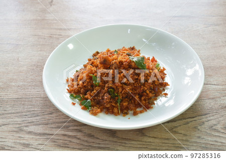 spicy fried crispy mashed catfish meat curry with lemon and basil on plate  97285316