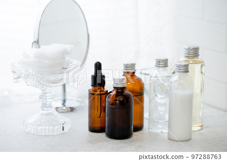 Skin care cosmetics bottles, mirrors and care cottons arranged behind a lace curtain 97288763