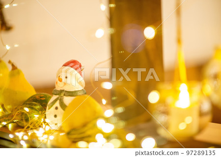 A snowman doll placed by the window 97289135