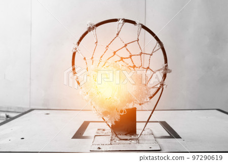 A basketball ring on a basketball court, a solar flare in the center 97290619