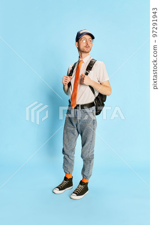 Portrait of young man, student in casual clothes posing isolated over blue background. First day at university 97291943