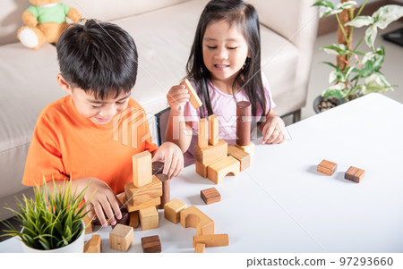 Happy little kids play wood block stacking board game at home, Children boy and girl playing with constructor wooden block, childhood activities learning creative, toys for preschool and kindergarten 97293660